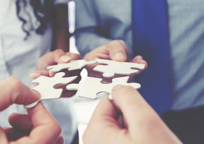 People putting puzzle pieces together
