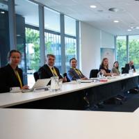 Several people in business clothing seated at a table
